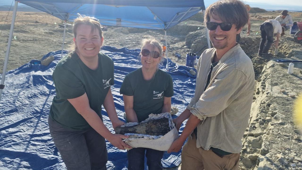 Carlijne, Esther, and Erwin holding a plastered bone