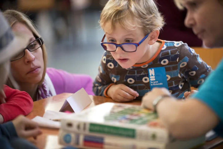 A boy studies his find during Nature questions