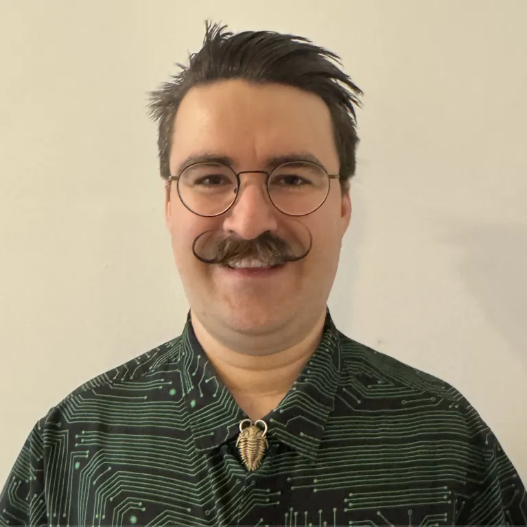 Picture of William against a blank wall.